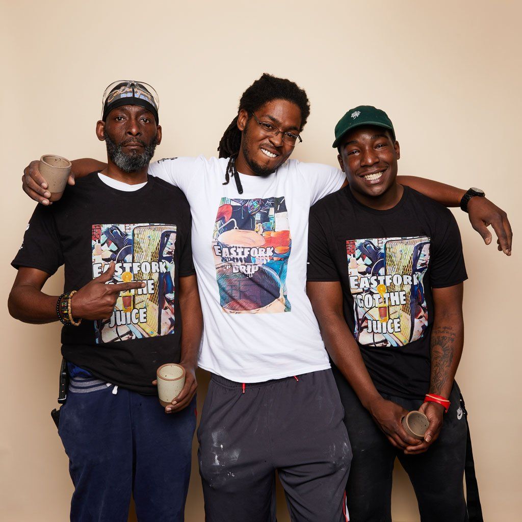 Three people wear East Fork t-shirts made by Drip Life in two designs on black or white tees.