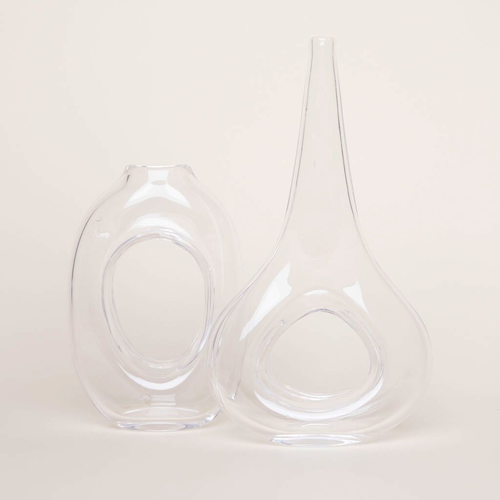 Two empty loop vases made of clear glass