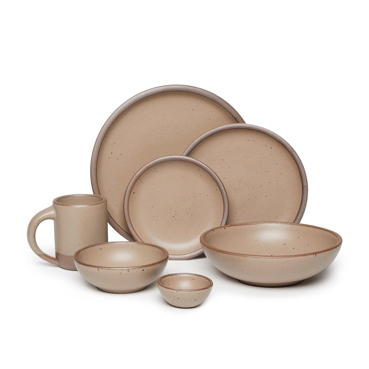 The Mug, bitty bowl, breakfast bowl, everyday bowl, cake plate, side plate and dinner plate paired together in a warm pale brown color featuring iron speckles