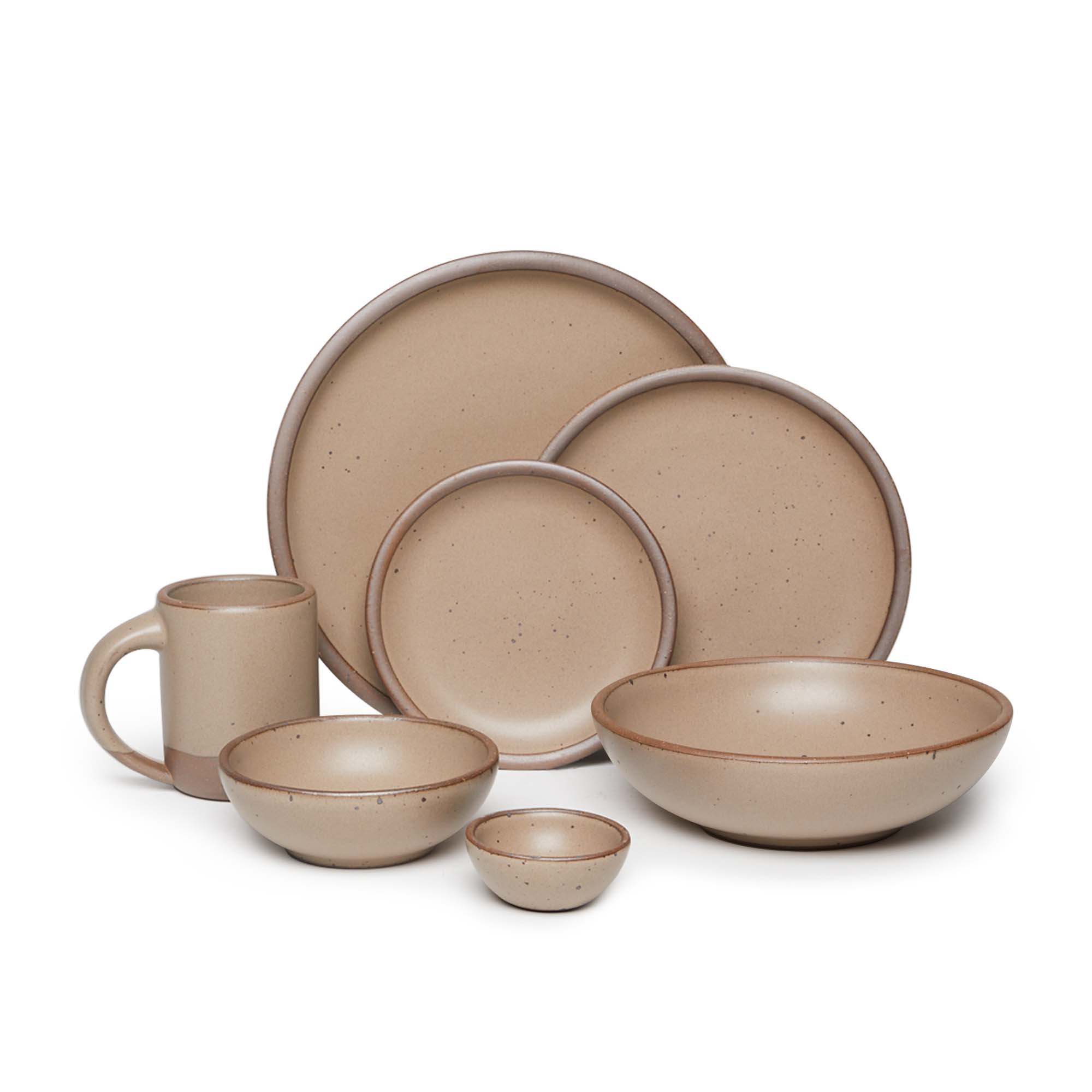 The Mug, bitty bowl, breakfast bowl, everyday bowl, cake plate, side plate and dinner plate paired together in a warm pale brown color featuring iron speckles