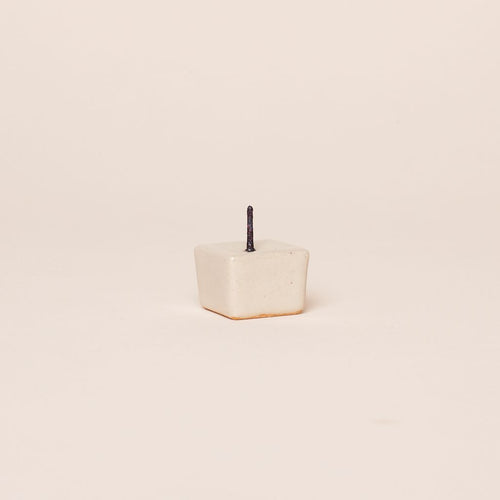 Beige ceramic candle stand with metal spike