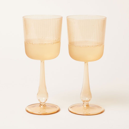 Two pale yellow wine glasses by R+D Lab