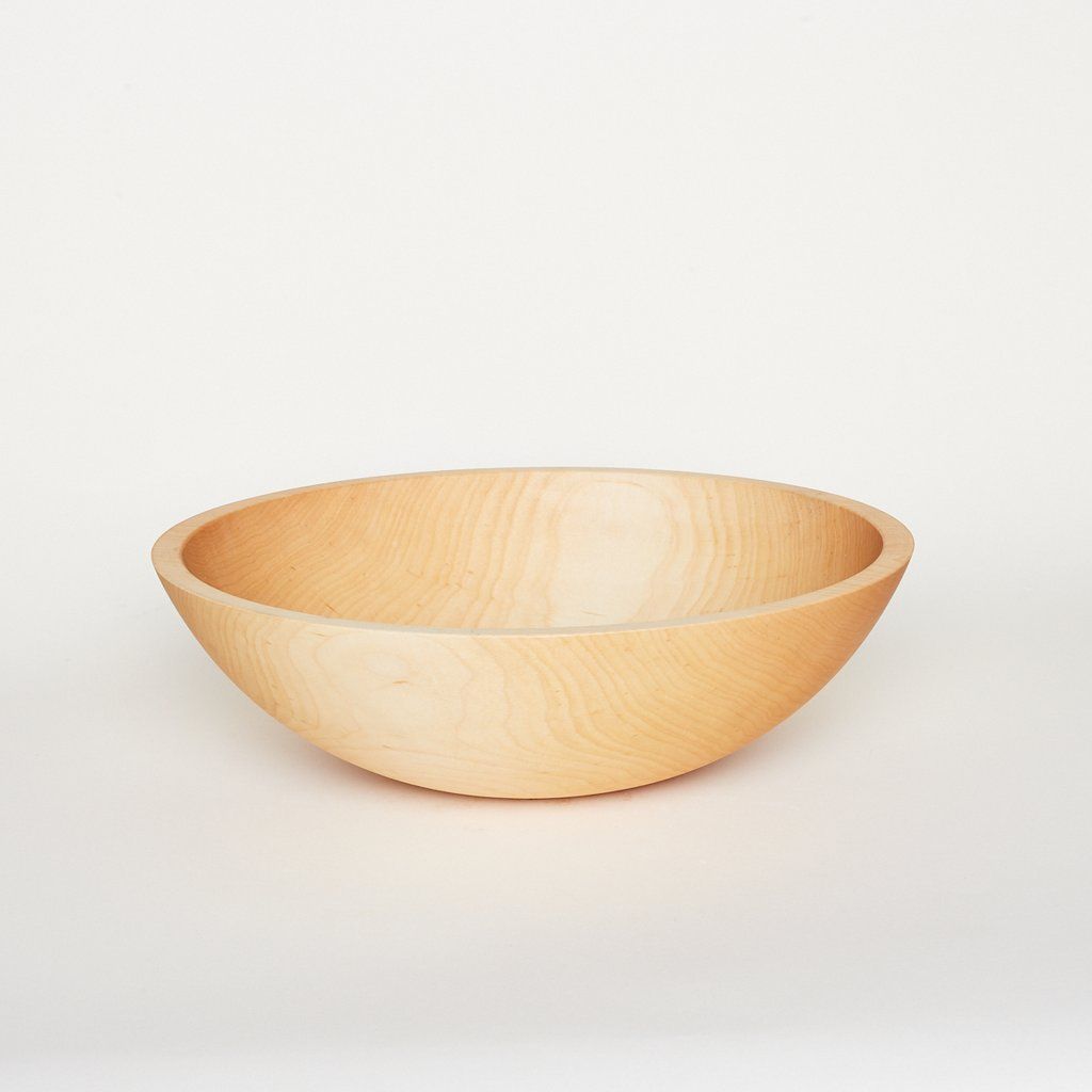 A large light-colored wooden bowl