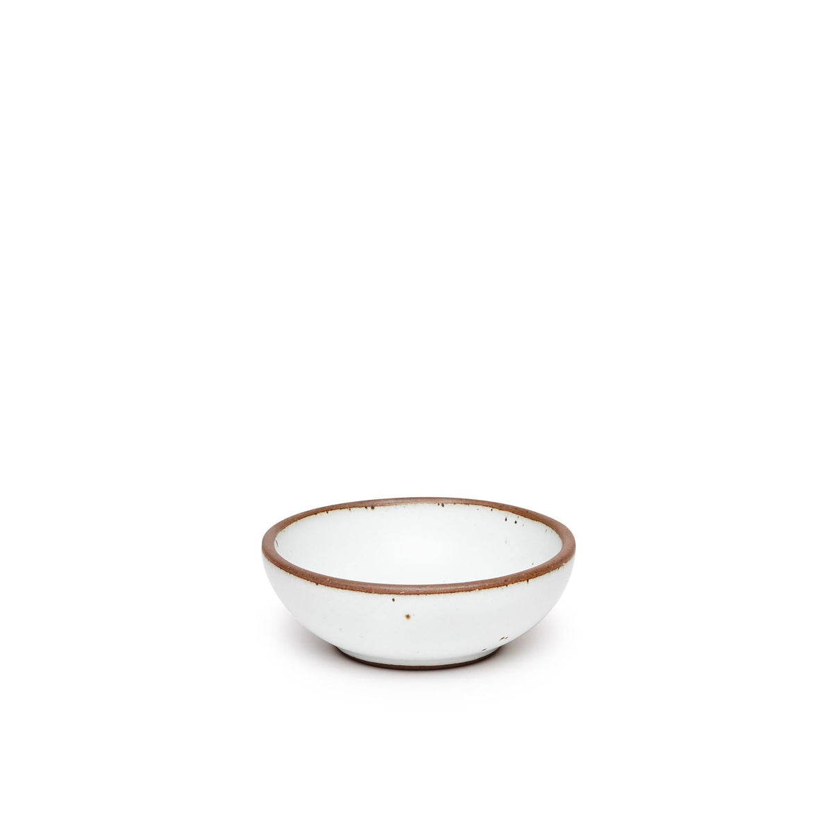 A small shallow ceramic bowl in a cool white color featuring iron speckles and an unglazed rim